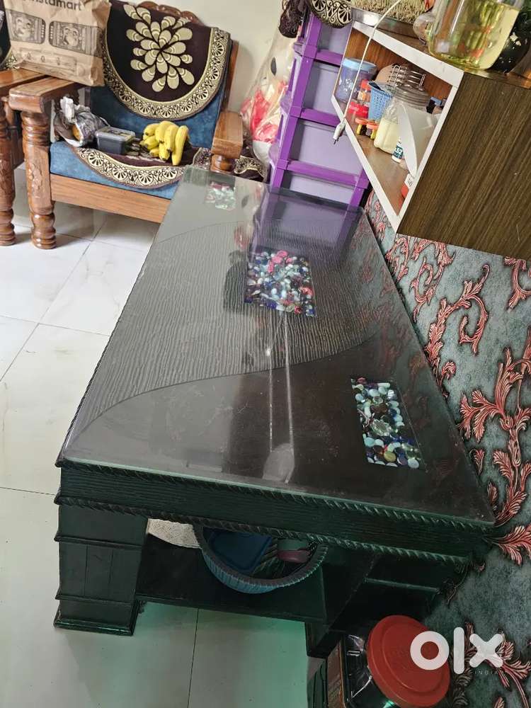 Wooden dining table with glass top