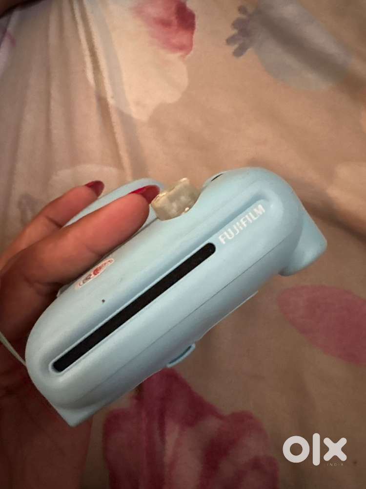Instax Mini 11 instant camera in Sky Blue.