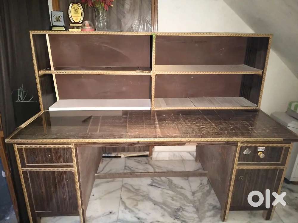 It is a long, big and comfortable wooden study table.
