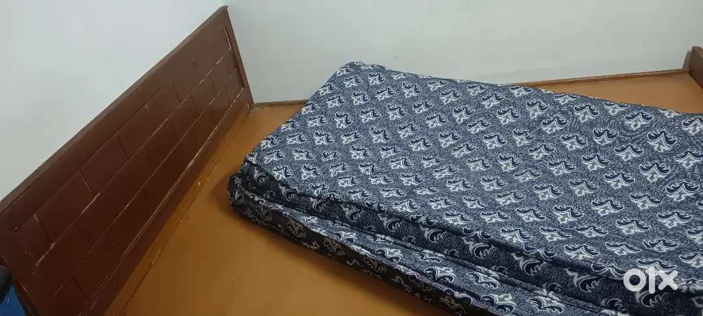 Wooden cot with bed