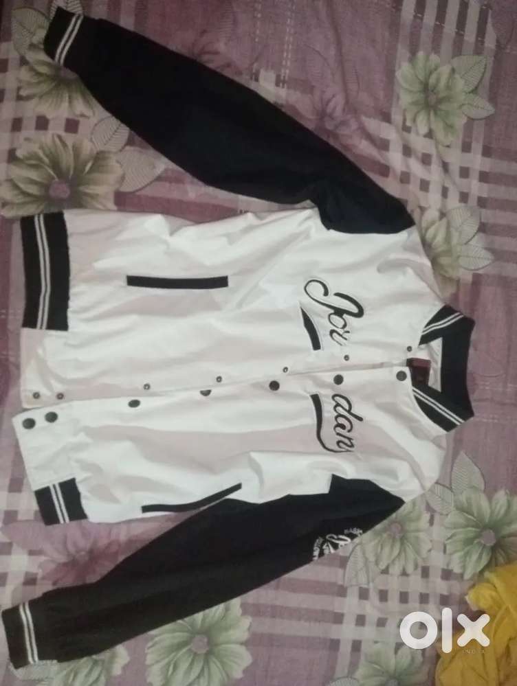 A varsity jacket of black and white coloured , size - L