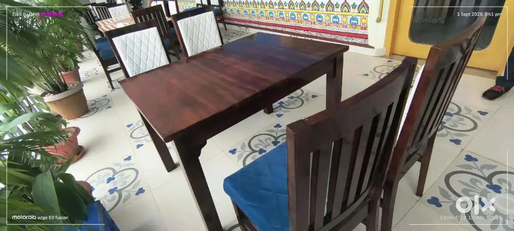 A teak wood 4-seater dining set