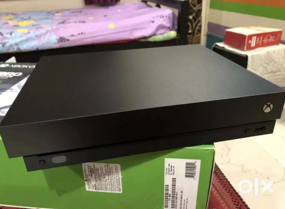 Xbox One X 1TB 4K gaming console with 4 discs