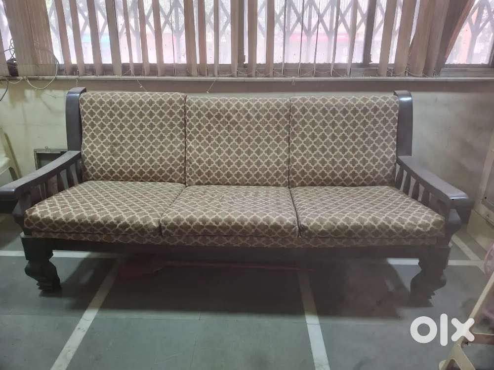 Teak wood sofa and two chairs with signature cushions and top covers