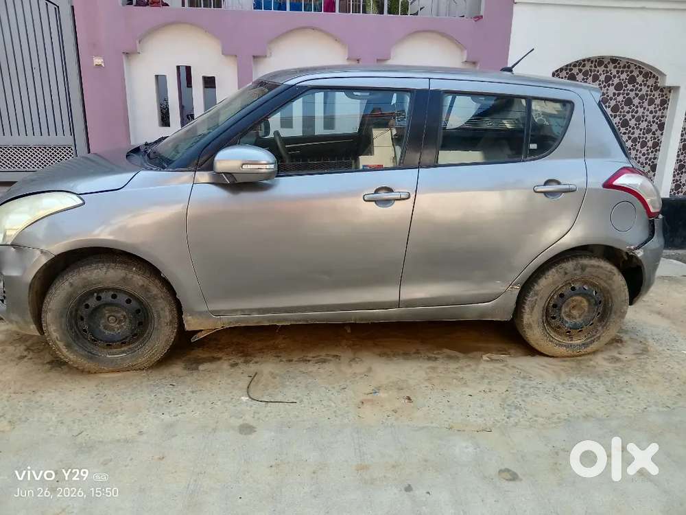 Car Is Of Grey Colour And Some Parts Are Damage