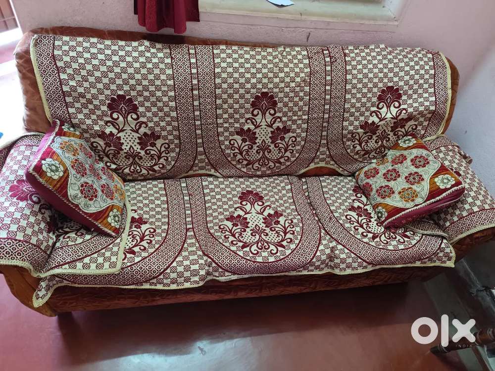 Brown velvet three-seater sofa