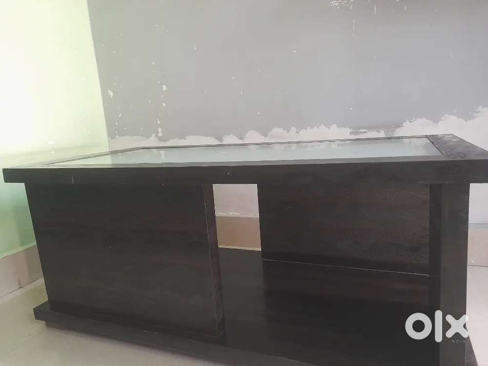 Dark brown wooden center table with glass top