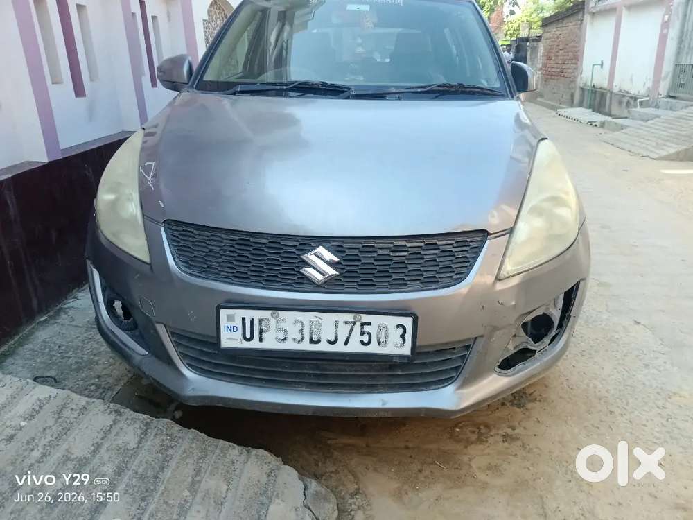 Car Is Of Grey Colour And Some Parts Are Damage