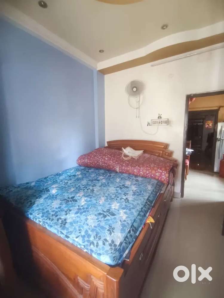 100% shegun wood box bed(king size), has a head board with design.