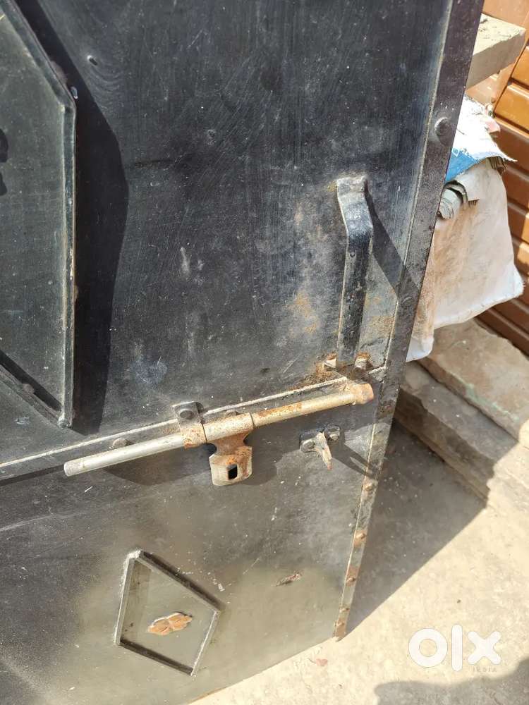 Old heavy GI metal door with fittings and accessories.