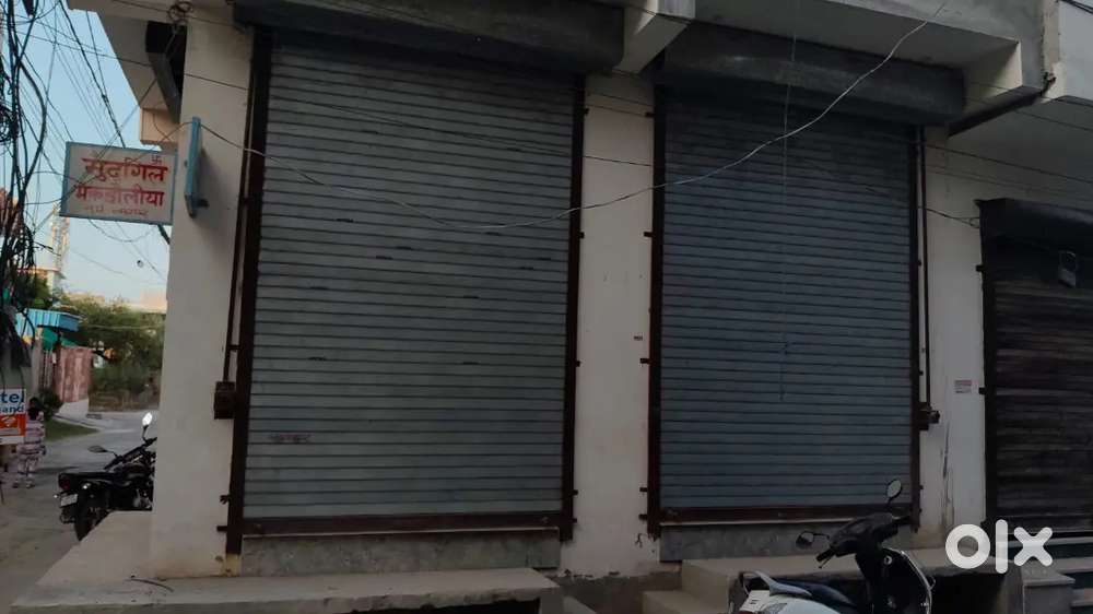 One shop with double side shutter & one with single side shutter open