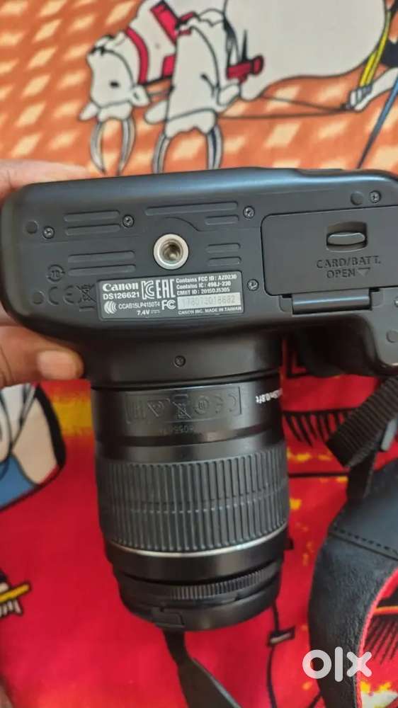 a black Canon EOS 1300D DSLR camera with an attached Canon