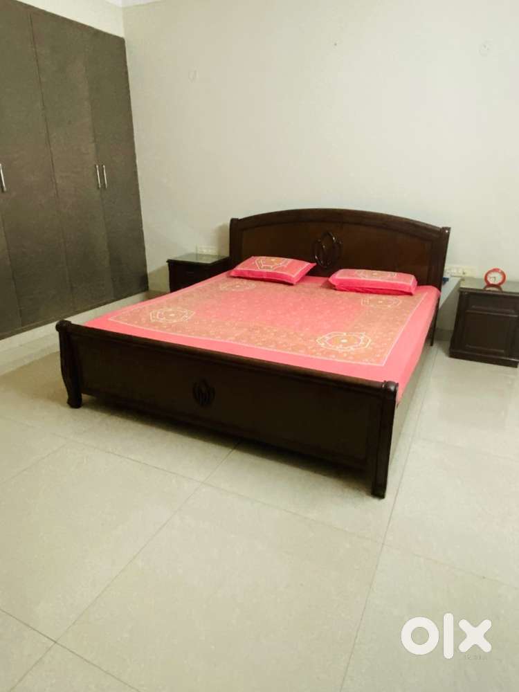 Wooden box double bed with side table glass top .