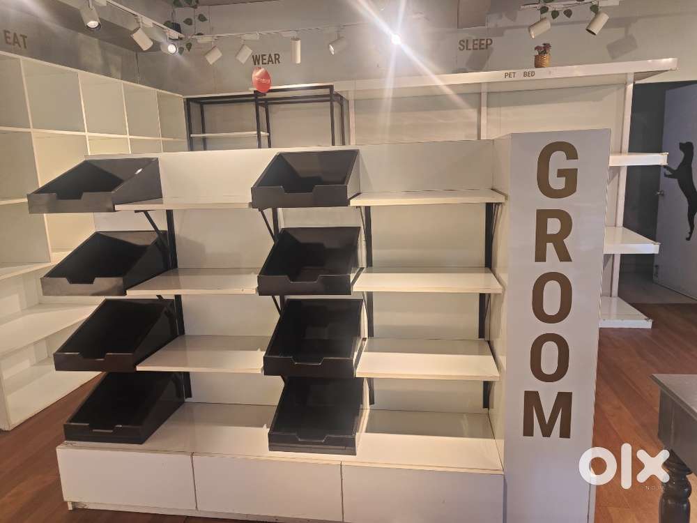 Grooming Display with removable black boxes. Slat wall behind.