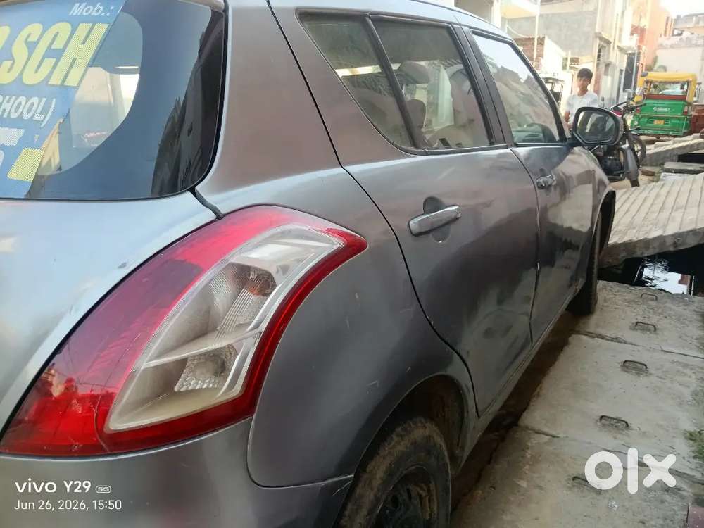 Car Is Of Grey Colour And Some Parts Are Damage