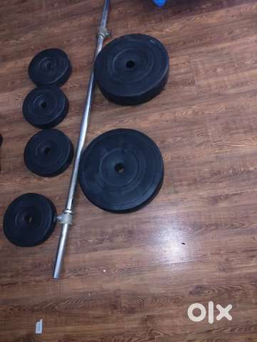 Exercise Rod and weight Plates for biceps chest Shoulders gym