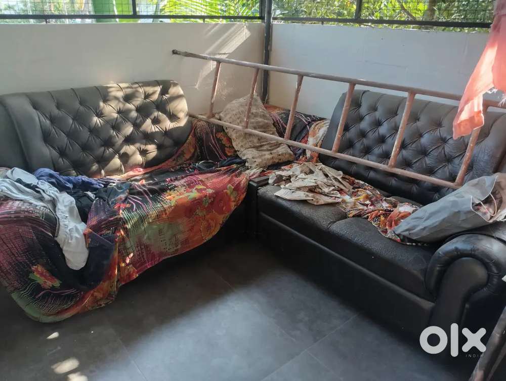 Old sofa, black, lots of wear and tear