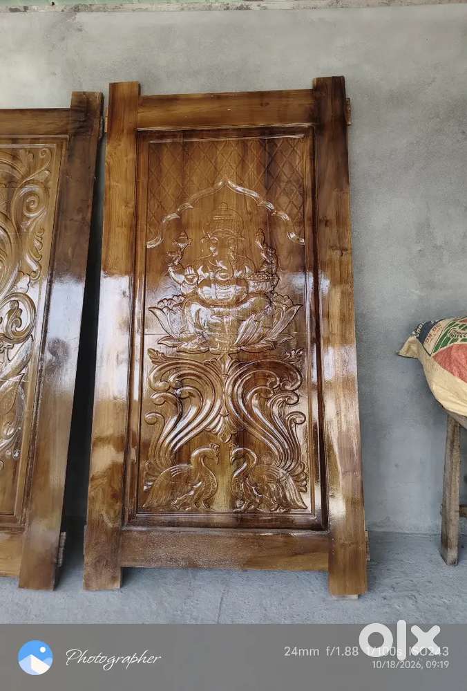door featuring an intricate carved peacock design (Mayur) with a gloss