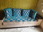5 seater sofa with a glass center table and 1 showcase
