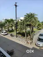 Garden facing open car parking space