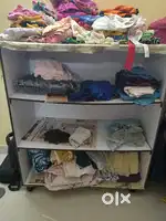 Wooden shelf with 3 compartments with wheels and provision for curtain