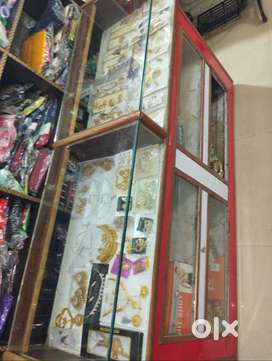 Shop counter with glass display and red and white  wooden counter