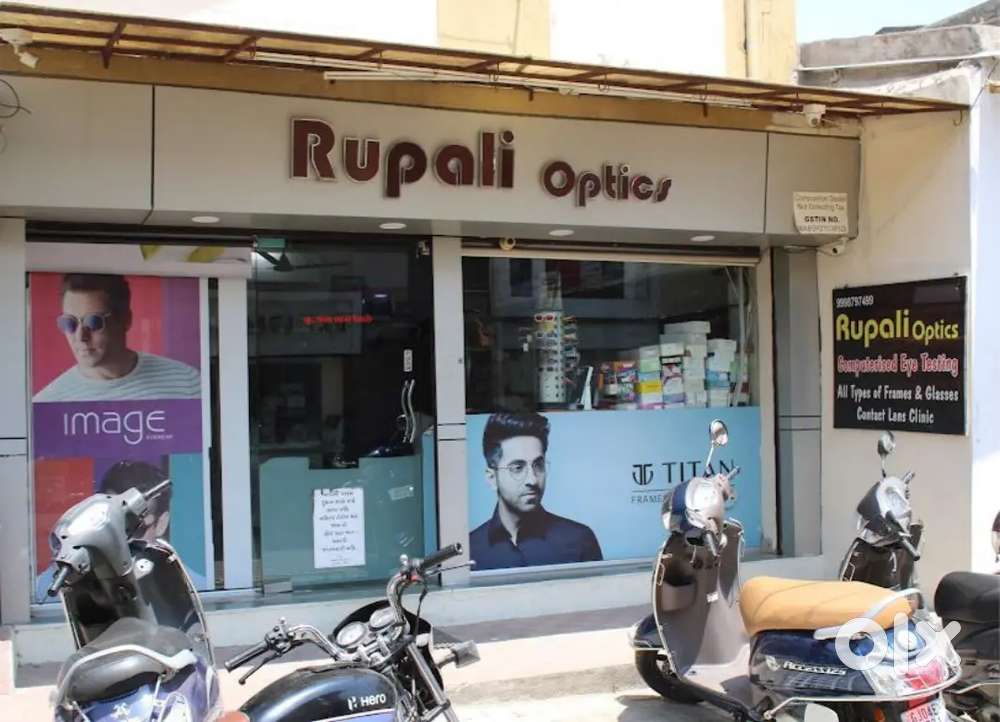 Salesman and helper in optics showroom