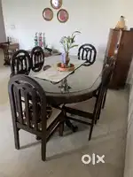 Dining table with Glass top & 6 cushion chairs.