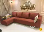 Brown fabricated L shape sofa with pillow