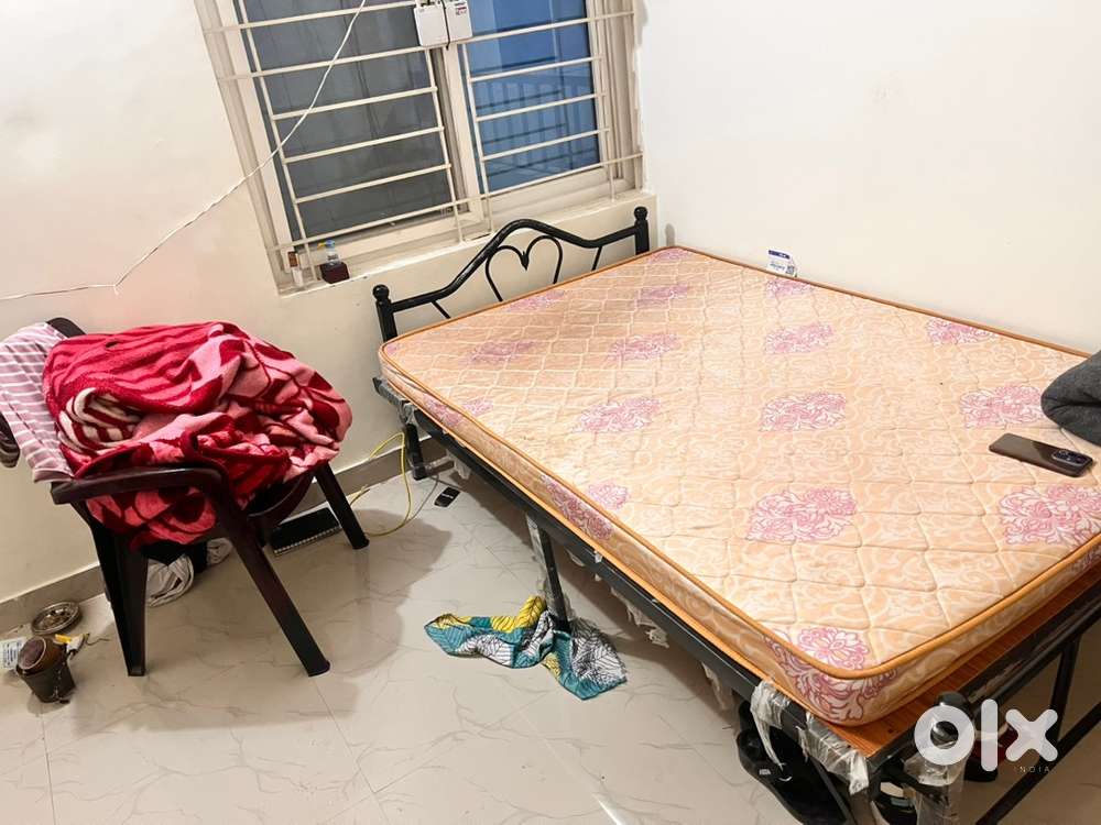 Bed with mattress and chair