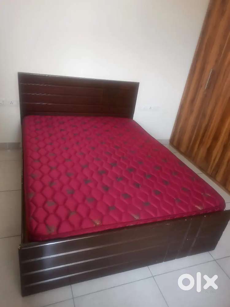 Wooden double bed with mattress