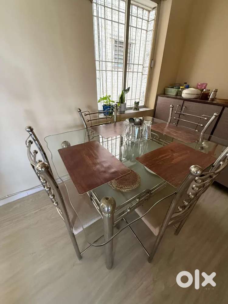 Glass and Steel dining table with 4 chairs