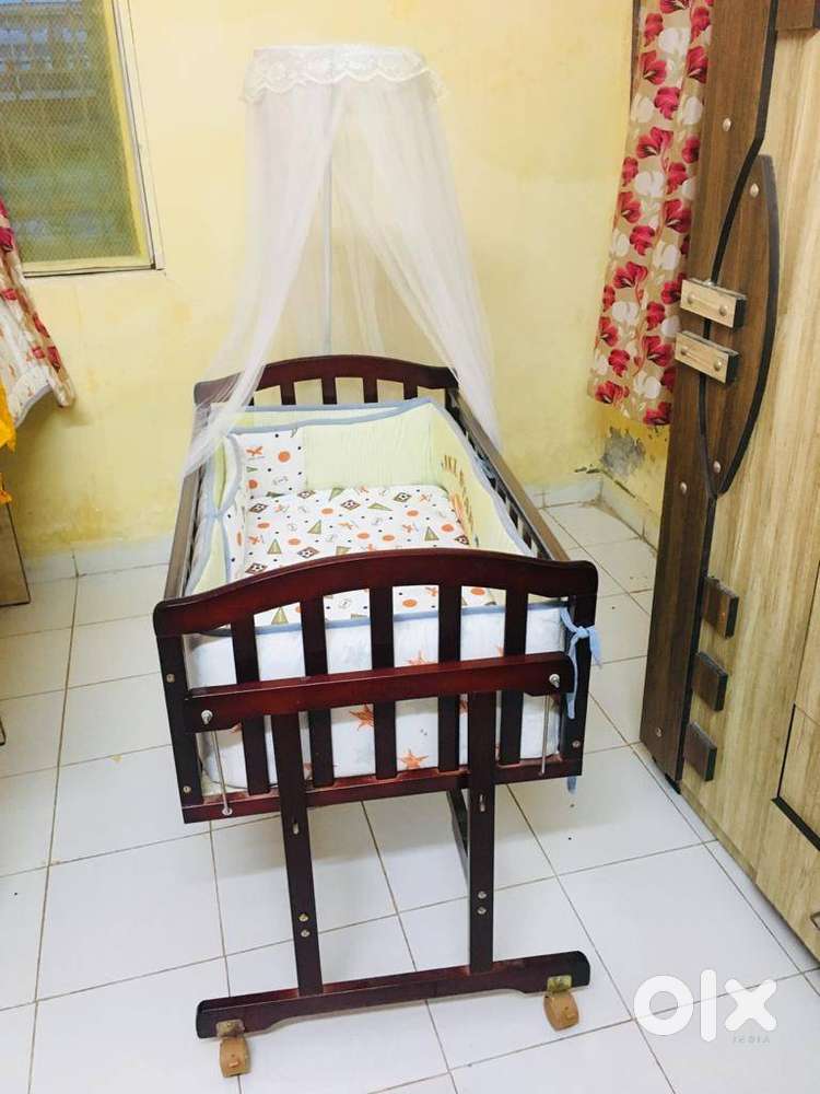 Baby craddle with crib set includes Bumpers and bedding with mattress.