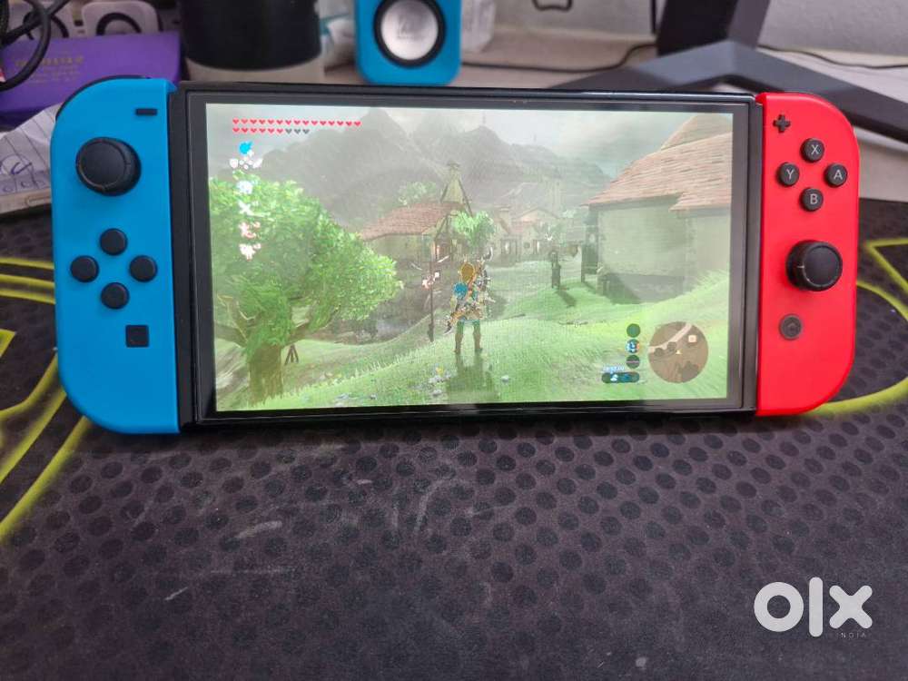 Nintendo Switch Oled in excellent condition with 3 game cartridge