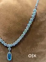 Elegant Diamond Loop Necklace with Blue Teardrop Pendant