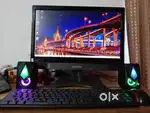 A classic monitor and keyboard with two speaker and a mouse
