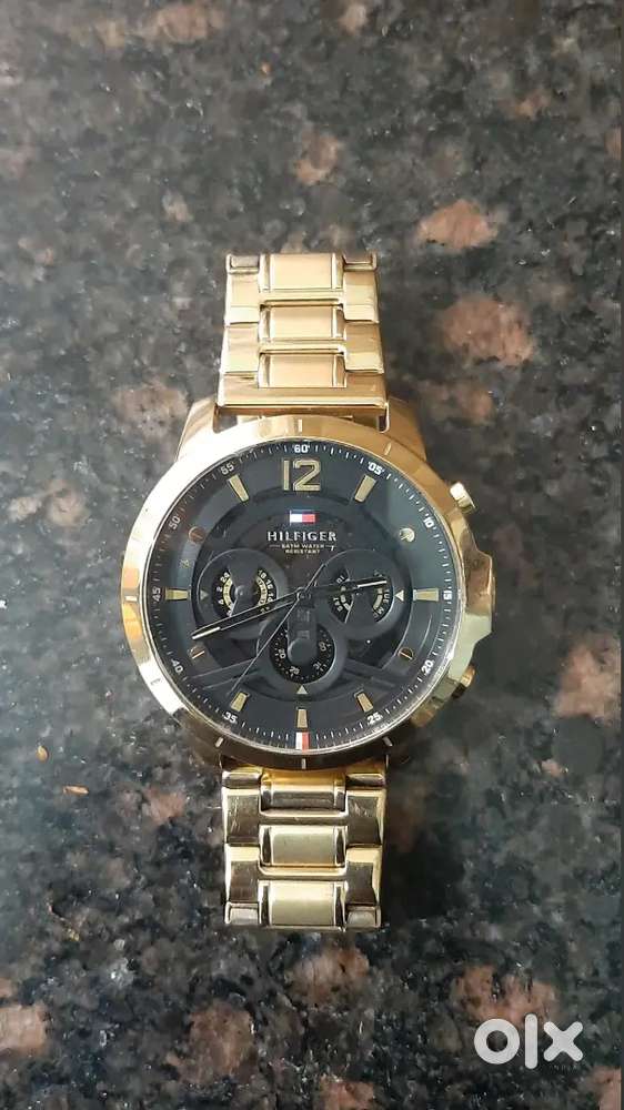 Tommy Hilfiger Gold watch with black dial ..Analog