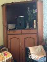 Showcase, glass table, wooden wardrobes and a bed