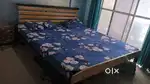 King size wooden bed with kurl on mattress