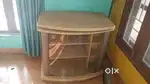 A rubber wood rotating tv unit  with glass shelf