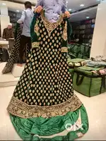 Rich emarald green velvet Bridal Tail-cut Gown with Heavy Duppata.