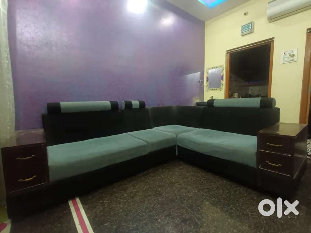 L shape sofa set with pillows.