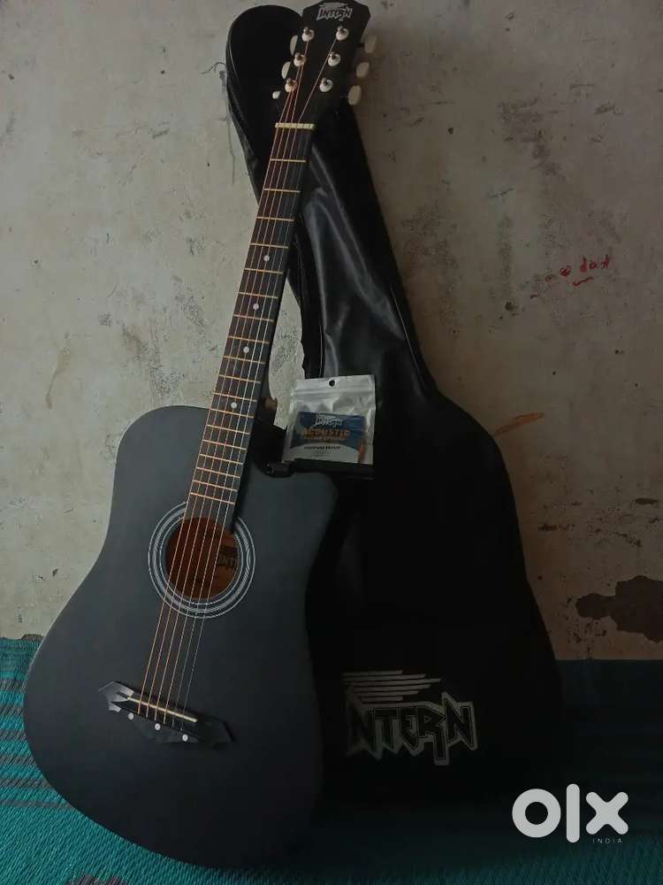 Intern acoustic guitar with extra strings, plectrums and bag of guitar