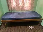 Single wooden bed with mattress