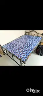 Steel cot with bed