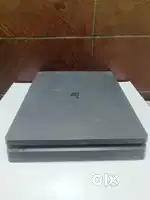 PlayStation 4 with game CDs and controller