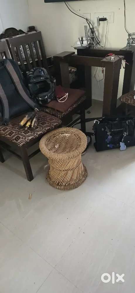 A wooden dining table with 4 chairs