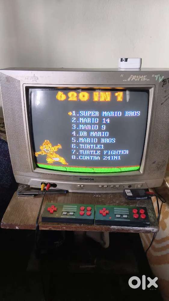 Old colour tv with video game console for sale