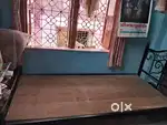 Single wrought iron bed with plywood