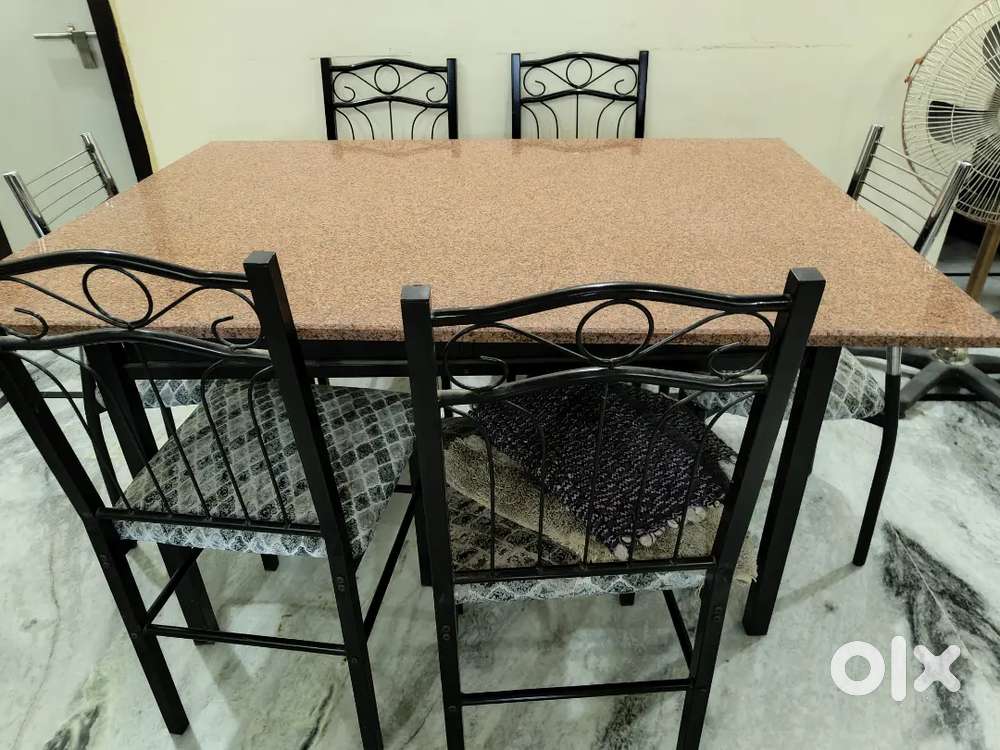 Dinning table very good condition with marble 6 chair heavy metal